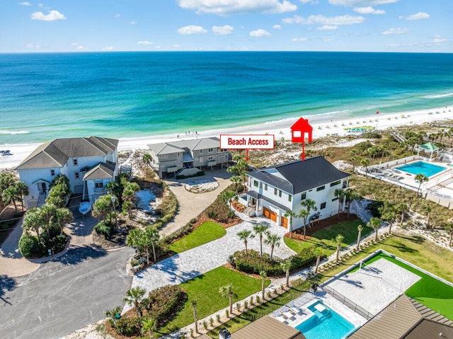 aerial view with a water view and a beach view