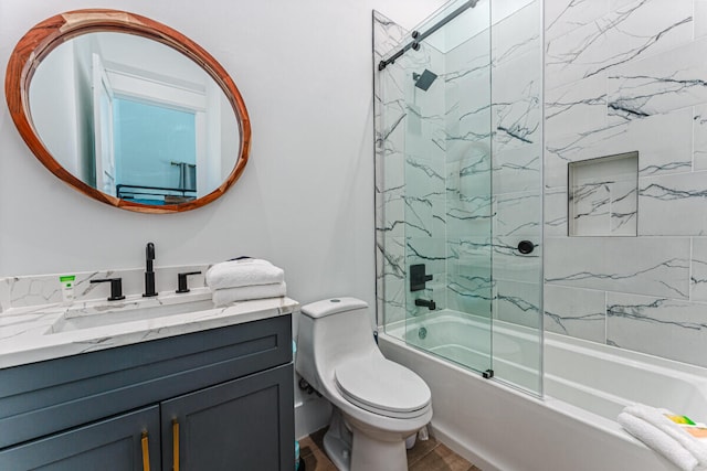 full bathroom with vanity, enclosed tub / shower combo, and toilet