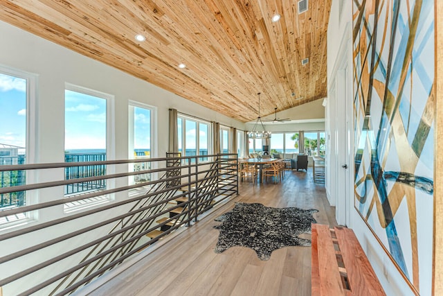 hall with wood-type flooring, wood ceiling, a water view, and vaulted ceiling