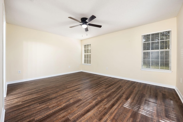 spare room featuring dark hardwood / wood-style flooring and ceiling fan