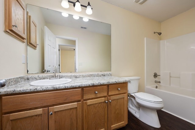 full bathroom featuring vanity, wood-type flooring, tub / shower combination, and toilet