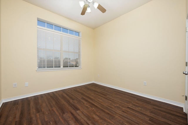 spare room with ceiling fan and dark hardwood / wood-style flooring