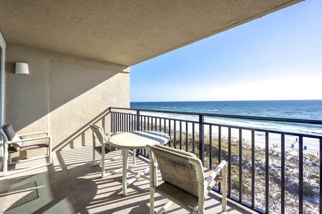 balcony featuring a water view and a view of the beach