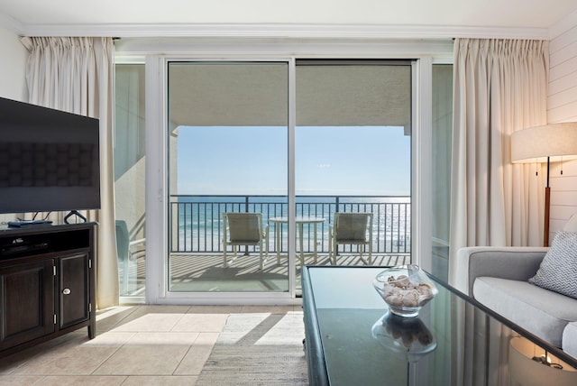 tiled living room with ornamental molding and a water view