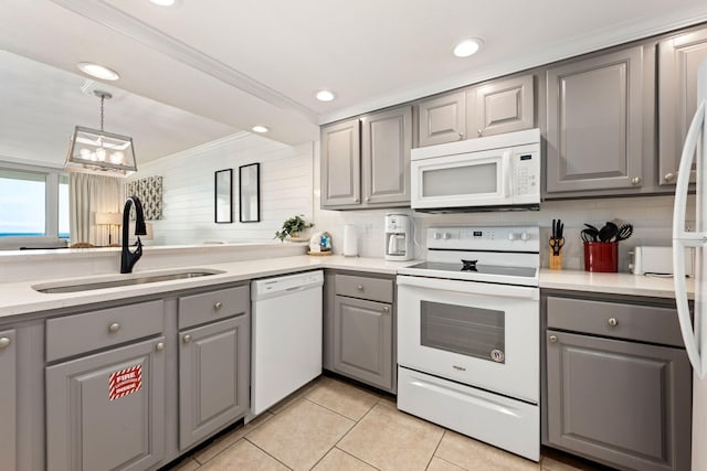 kitchen with white appliances, crown molding, sink, and gray cabinetry