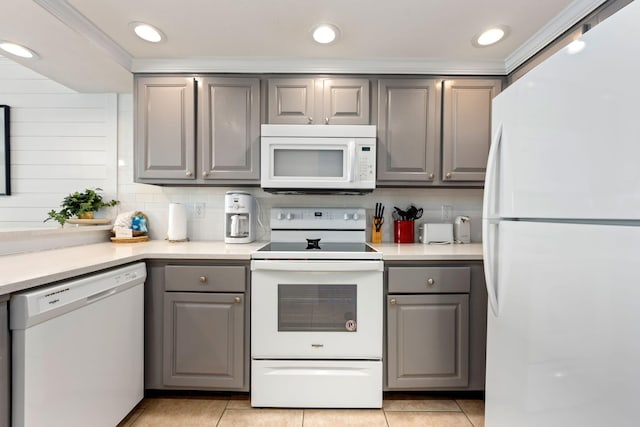 kitchen with light tile patterned floors, white appliances, tasteful backsplash, and gray cabinetry