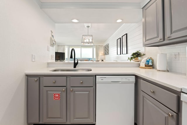 kitchen featuring sink, gray cabinets, tasteful backsplash, dishwasher, and crown molding