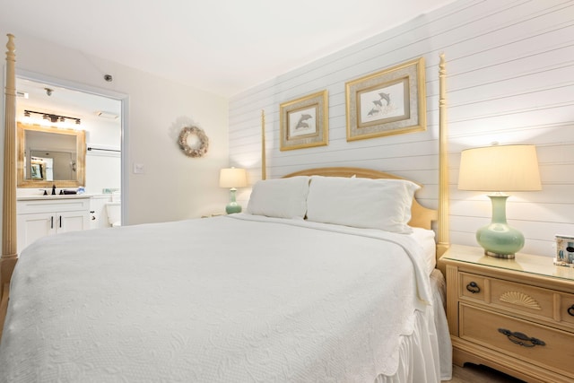 bedroom featuring ensuite bath and sink