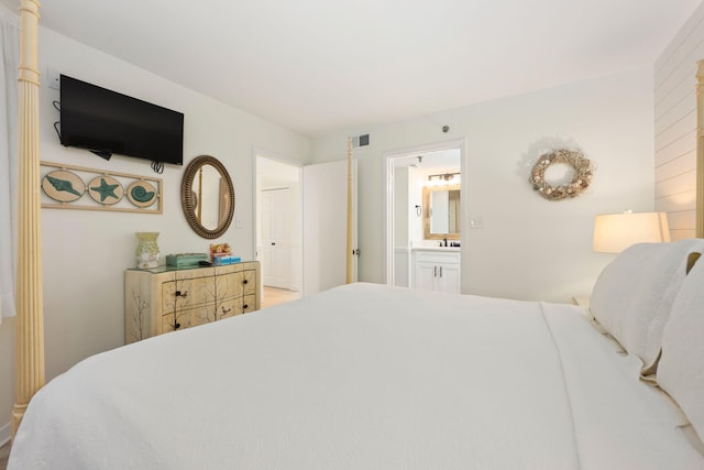 bedroom featuring sink and ensuite bathroom