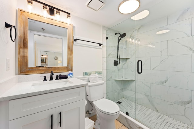 bathroom featuring toilet, a shower with door, and vanity