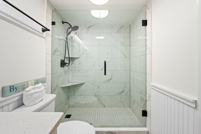 bathroom with vanity, toilet, and a shower with shower door