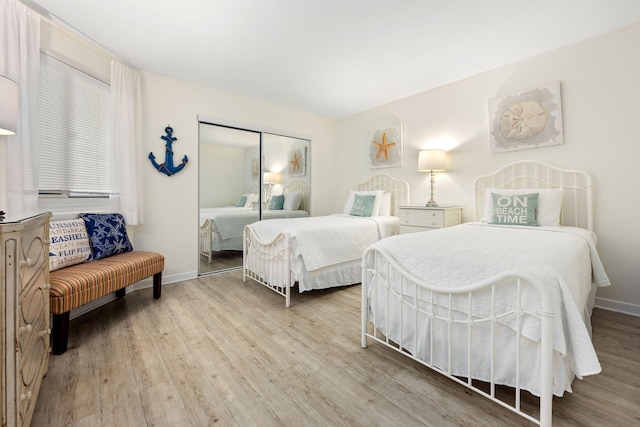 bedroom featuring light hardwood / wood-style flooring and a closet