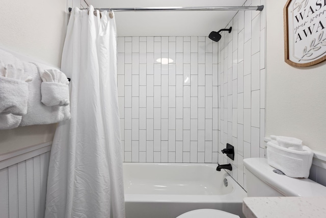 bathroom with shower / bath combination with curtain and toilet