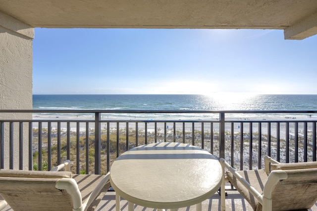 balcony with a water view and a beach view