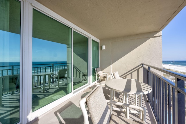 balcony with a beach view and a water view