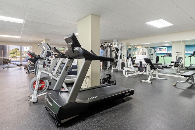 gym with a paneled ceiling