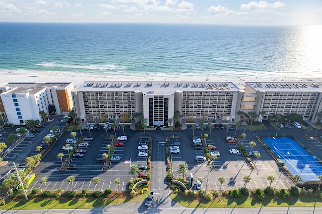 bird's eye view with a water view and a beach view