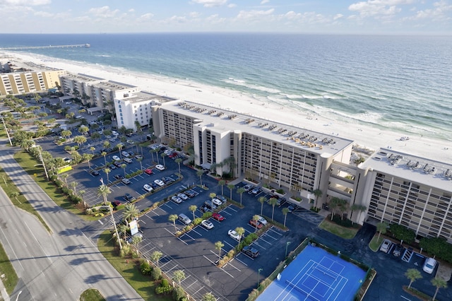 bird's eye view with a water view and a beach view