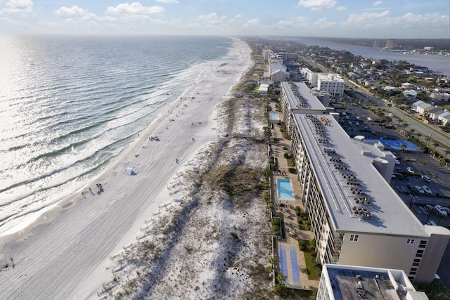 bird's eye view featuring a water view and a beach view