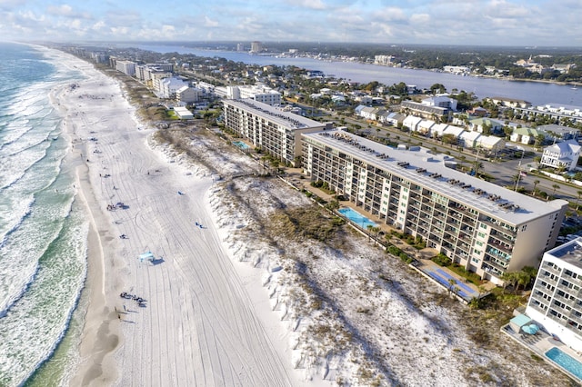 drone / aerial view featuring a water view and a beach view