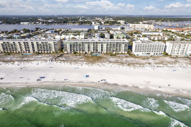 drone / aerial view featuring a water view and a beach view