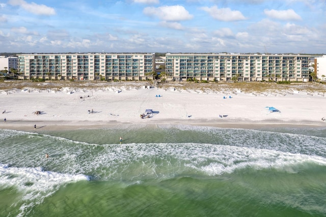 drone / aerial view with a water view and a beach view