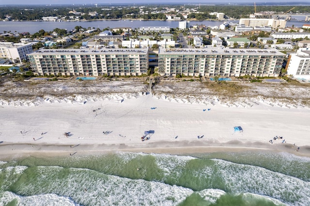 birds eye view of property with a water view and a view of the beach