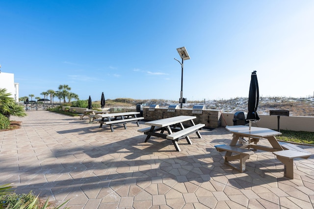 view of community featuring a patio area and an outdoor kitchen