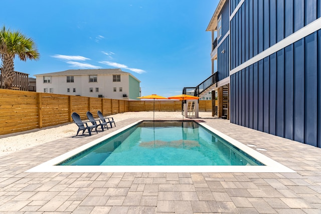 view of swimming pool with a patio