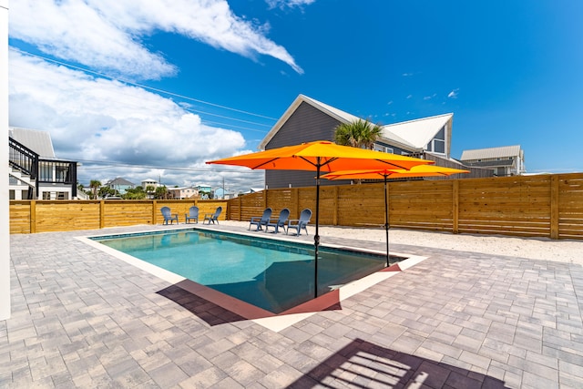 view of swimming pool with a patio area