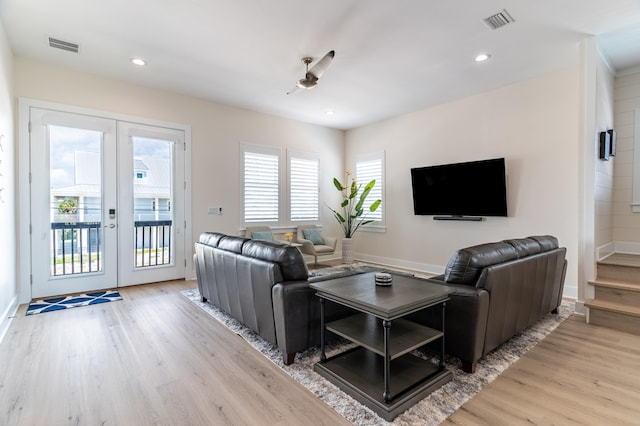 living room featuring french doors and light hardwood / wood-style floors