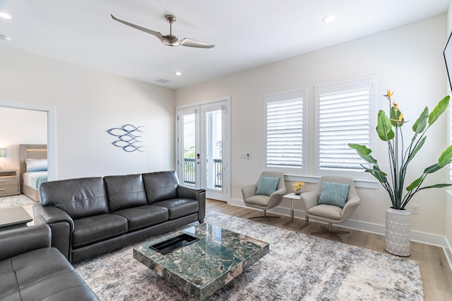 living room with light wood-type flooring and ceiling fan