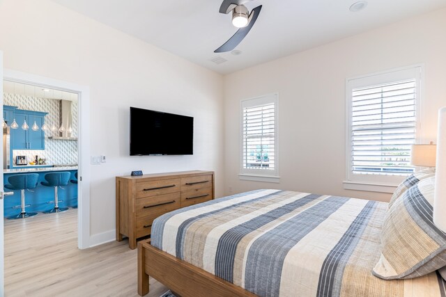 bedroom with light hardwood / wood-style flooring and ceiling fan