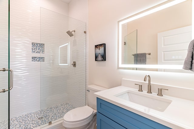 bathroom featuring vanity, toilet, and an enclosed shower