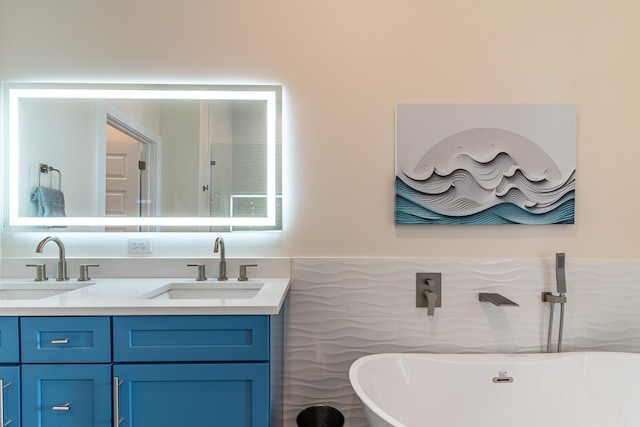 bathroom featuring vanity, a tub to relax in, and tile walls