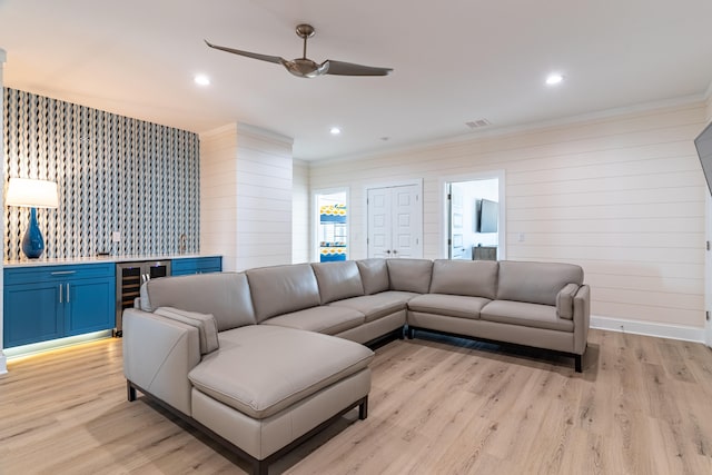 living room with wine cooler, ceiling fan, and light hardwood / wood-style flooring