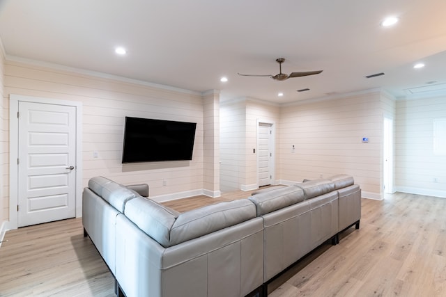 living room featuring wooden walls, light hardwood / wood-style floors, ceiling fan, and ornamental molding