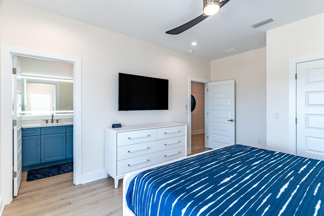 bedroom featuring ceiling fan, light hardwood / wood-style floors, ensuite bathroom, and a closet