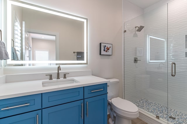 bathroom featuring vanity, toilet, and an enclosed shower