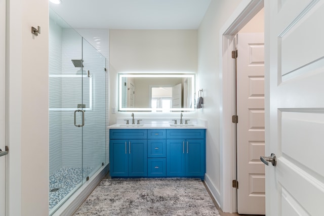 bathroom featuring vanity and an enclosed shower