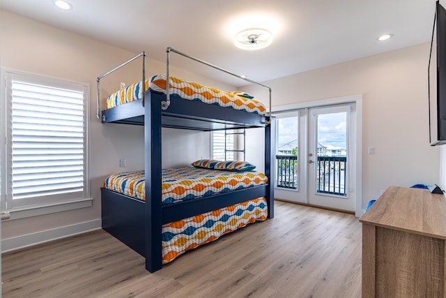 bedroom featuring access to exterior and hardwood / wood-style flooring