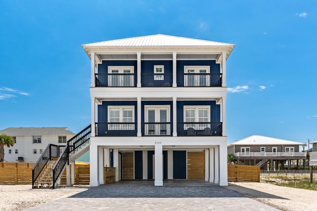 coastal home featuring a carport and a balcony