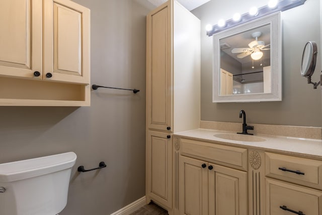 bathroom with vanity, toilet, and ceiling fan