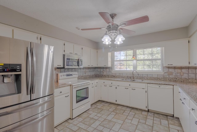 kitchen featuring white cabinets, sink, ceiling fan, tasteful backsplash, and stainless steel appliances