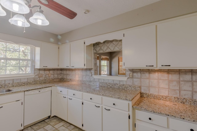 kitchen with ceiling fan, dishwasher, tasteful backsplash, light stone counters, and white cabinets