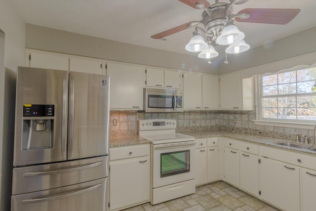 kitchen with backsplash, sink, white cabinetry, and stainless steel appliances