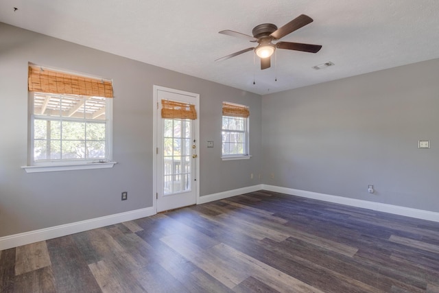 interior space with a textured ceiling, dark hardwood / wood-style floors, and ceiling fan