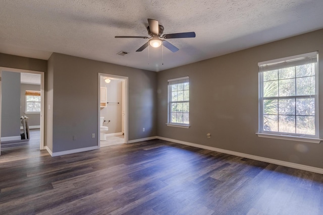 unfurnished bedroom featuring ceiling fan, dark wood-type flooring, and multiple windows