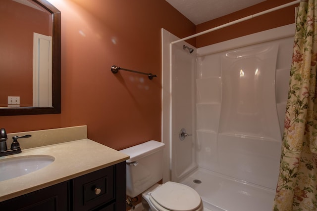 bathroom with vanity, toilet, and walk in shower