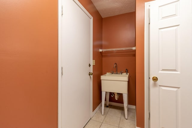 washroom with light tile patterned floors and a textured ceiling